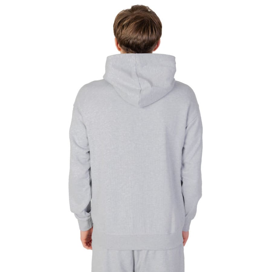 Boy models urban style clothing, grey hoodie and shorts from Underclub Men Sweatshirts