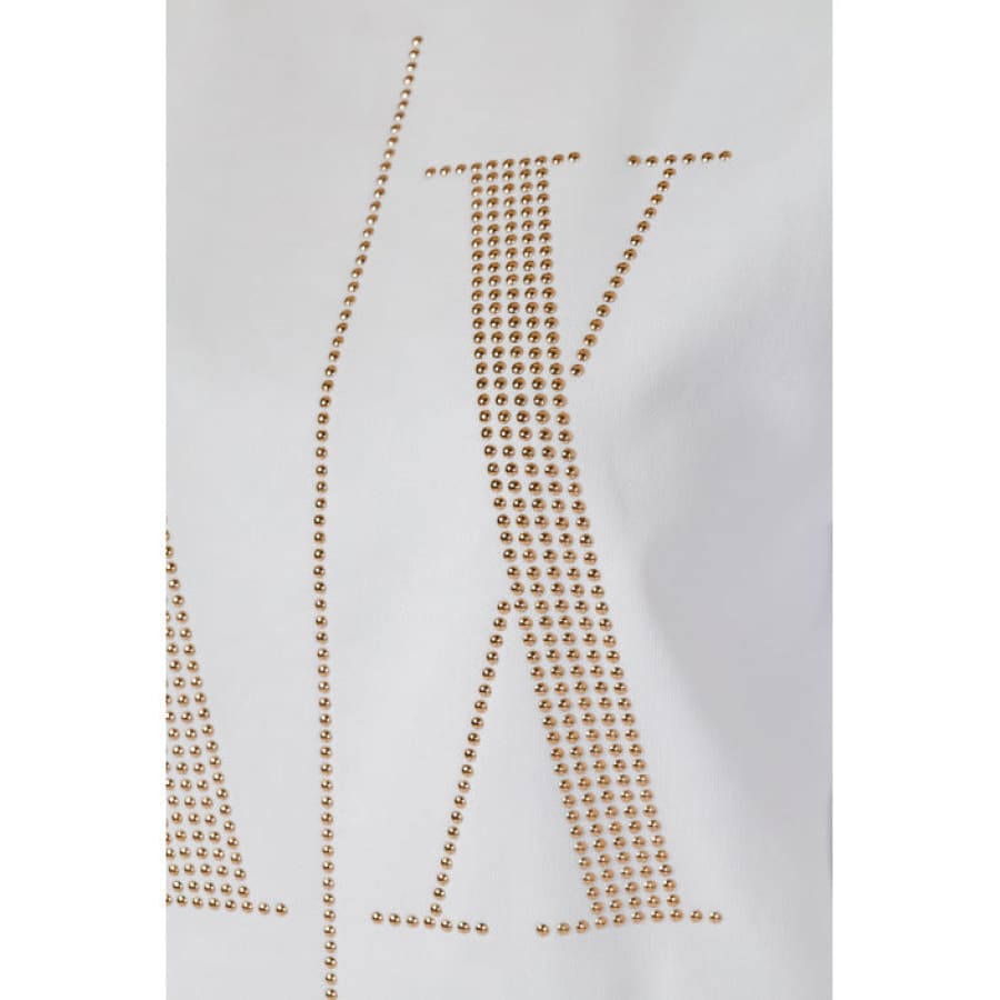 Armani Exchange gold necklace with letter accessory featured on women’s sweatshirt