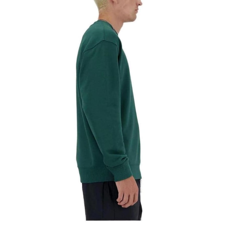 Man in New Balance green sweater embodying urban city style fashion