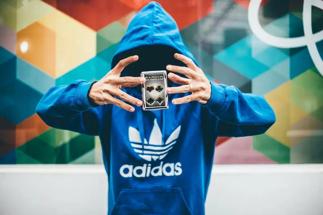 Person taking a selfie in urban city with Adidas style
