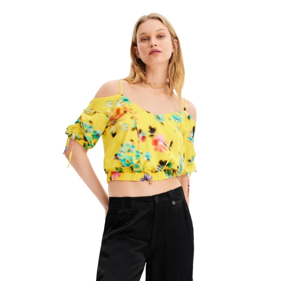 Woman in yellow floral blouse embodying urban city style