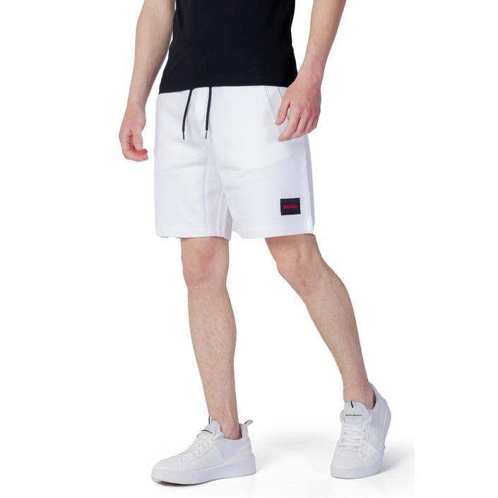 Man in urban city styles: black t-shirt, white shorts