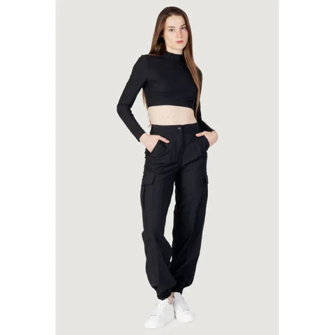 Woman in black crop top and women’s trousers from top brands