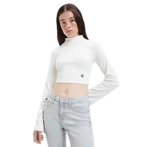 Woman in white crop top and jeans from women’s fashion collection