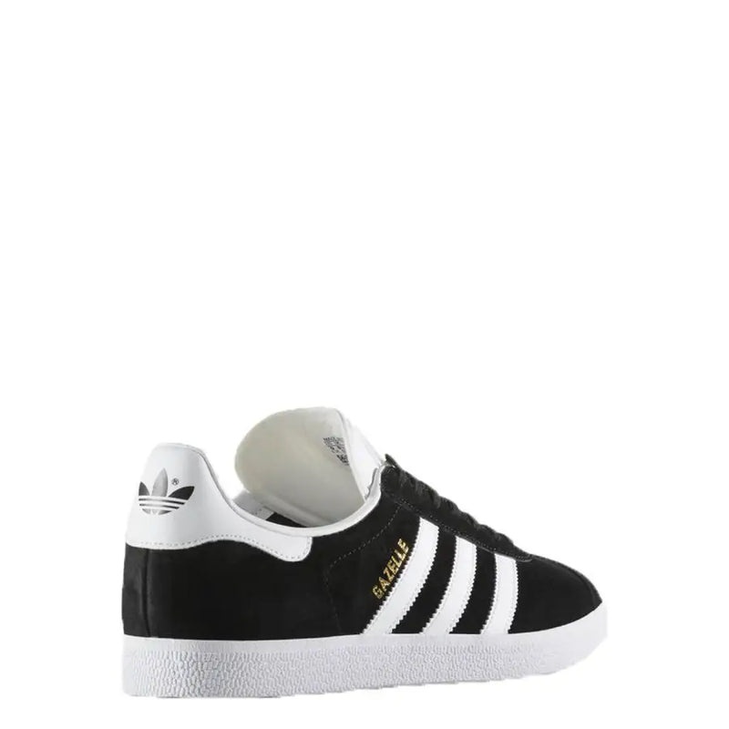Black and white adidas gazelle sneaker with gold accents.