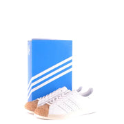 Adidas men leather sneakers white sporty slip on featuring cork toe cap and classic three stripes design