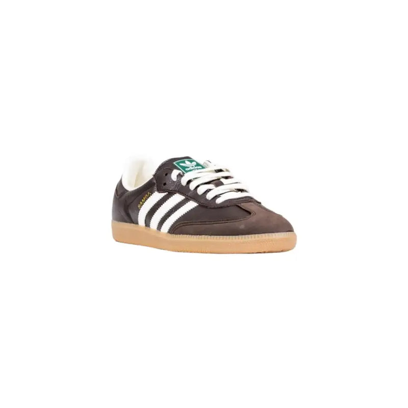 Brown leather adidas gazelle sneaker with white stripes and green accents.