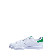 White leather adidas stan smith sneaker with vibrant green synthetic heel tab and matching green branding on the tongue
