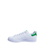 White leather adidas stan smith sneaker with vibrant green synthetic heel tab and matching green branding on the tongue