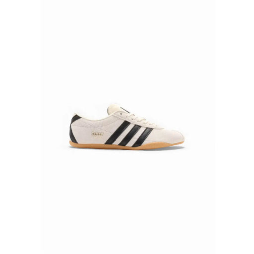 Cream-colored adidas originals women suede sneakers with black three stripes and a gum rubber sole