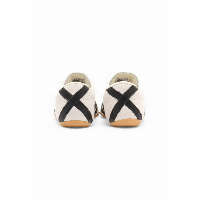 Adidas Originals women’s suede sneakers in white with cream canvas, black cross straps, and tan rubber sole
