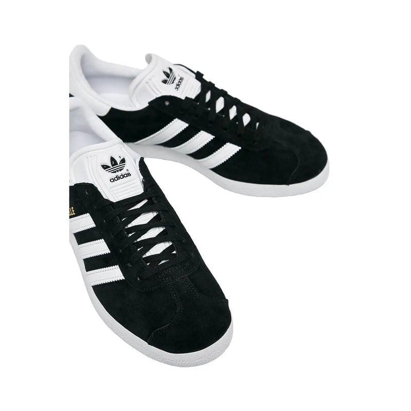 Adidas women black sneakers in suede with white rubber soles and polyurethane lace up featuring three stripes