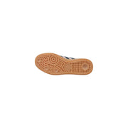 Back side of adidas women pink leather slip on sporty sneakers featuring a tan rubber sole with textured pattern and embossed logo