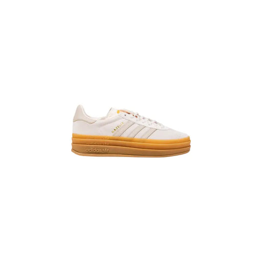 White Adidas Gazelle sneaker with tan sole and gold branding