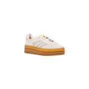 Cream-colored Adidas Gazelle sneaker with gum sole and black stripes
