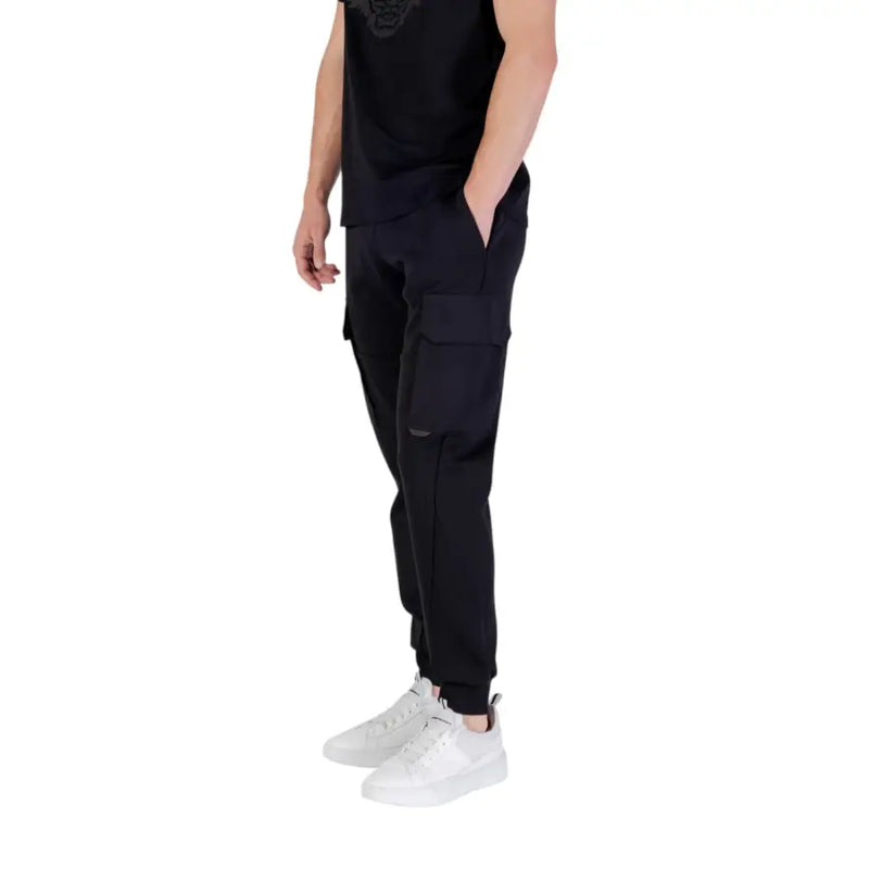 Men’s black cotton blend cargo trousers with elastic cuffs and white sneakers