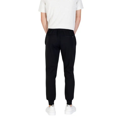 Men’s black tapered sweatpants with ribbed cuffs from Antony Morato featuring front and back pockets