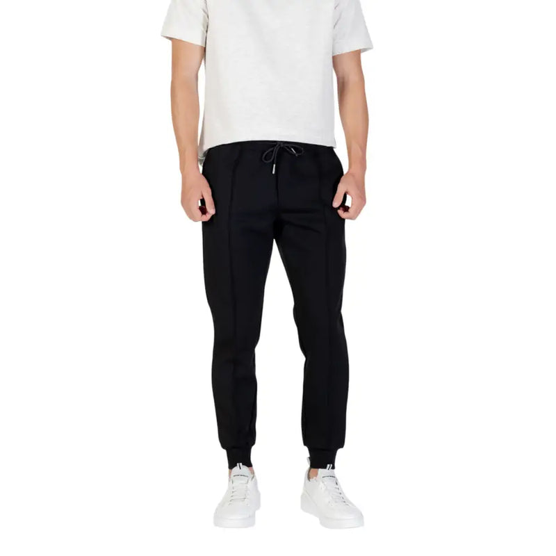 Men’s black joggers with white sneakers from Antony Morato featuring front and back pockets