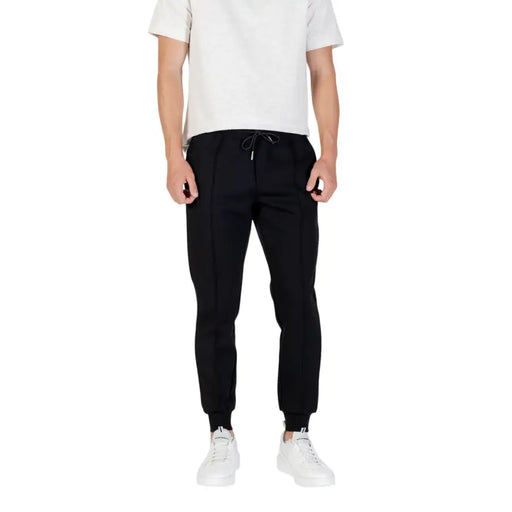 Men’s black joggers with white sneakers from Antony Morato featuring front and back pockets