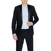 Men’s black tuxedo jacket with light blue dress shirt and black trousers for formal wear