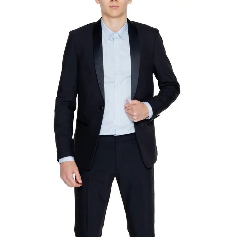 Men’s black tuxedo jacket with light blue dress shirt and black trousers for formal wear