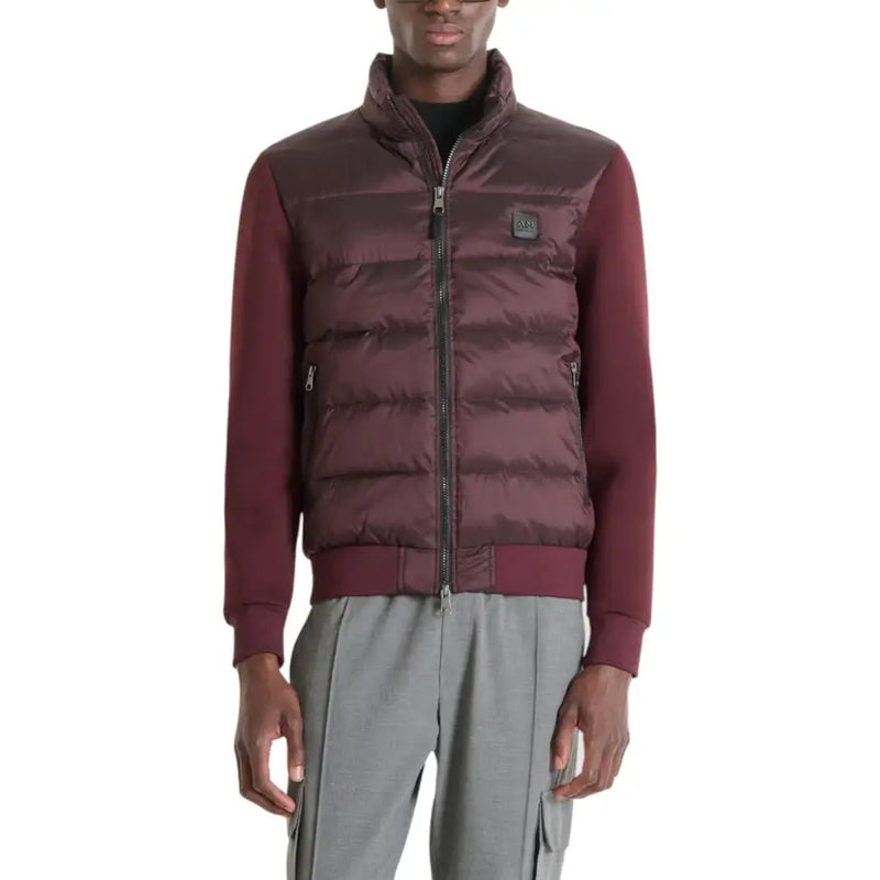 Burgundy quilted down vest with zipper closure and logo patch on chest.