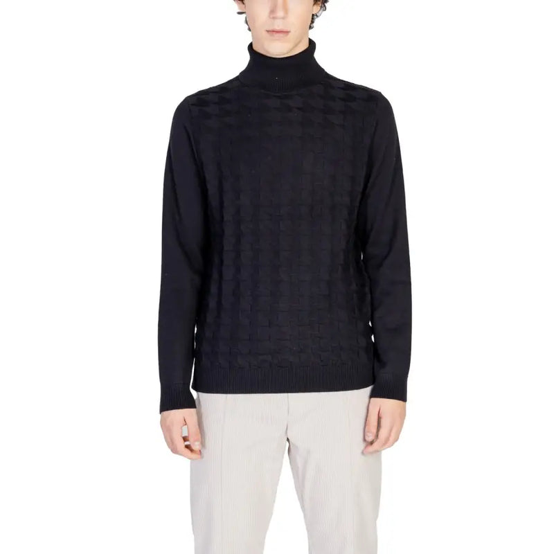 Black turtleneck sweater with geometric pattern and ribbed cuffs, likely made of wool or cotton blend.