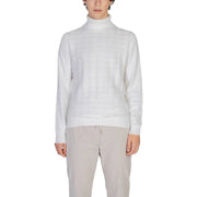 White turtleneck sweater with ribbed cuffs and hem, likely made of cotton or a similar soft material.