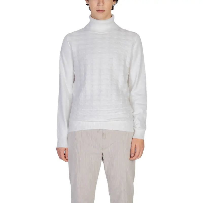 White turtleneck sweater with ribbed cuffs and hem, likely made of cotton or a similar soft material.