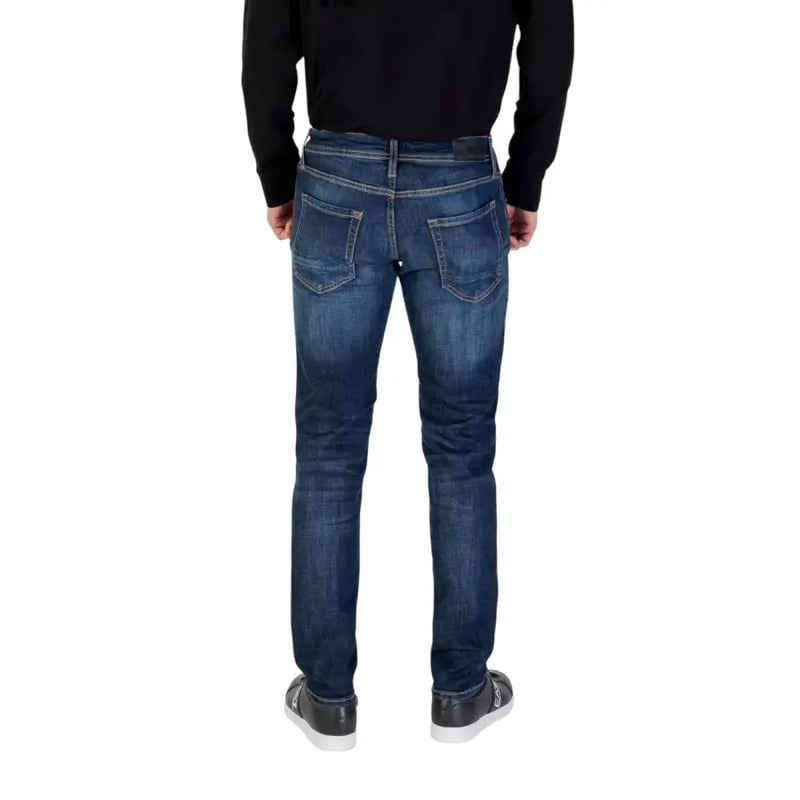 Blue denim jeans with distressed details and a slim fit.