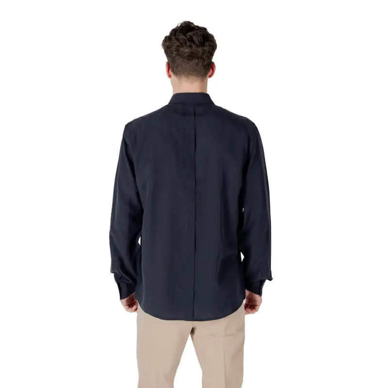 Men’s navy blue long-sleeve collared linen blend shirt with tan pants for sophisticated style
