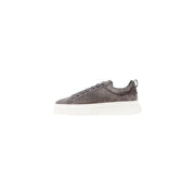 Dark gray leather sneakers with white soles and textured midsoles, inspired by alexander mcqueen.