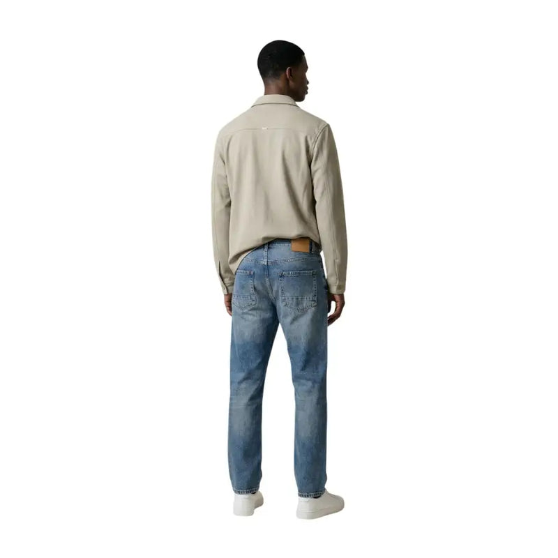 Beige cotton shirt with collar and long sleeves paired with blue denim jeans shown in Antony Morato Men blazer product