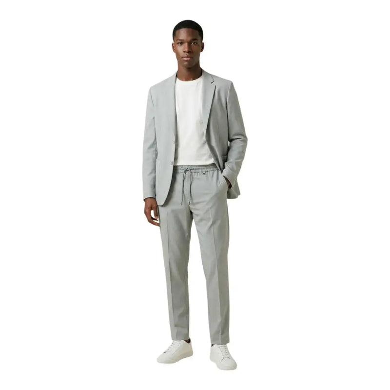 Antony Morato men blazer in a sleek light gray tailored suit with matching drawstring waistband pants and white sneakers