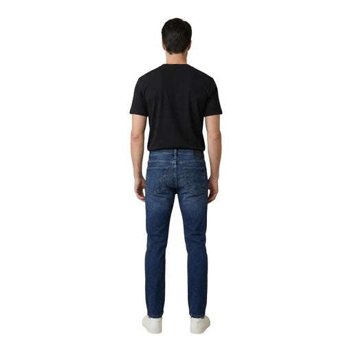 Antony morato men ozzy tapered fit blue cotton jeans shown from the back with dark blue slim fit denim and classic pockets