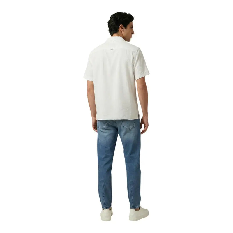 A man wearing the back side of an Antony Morato white short-sleeved polo shirt with a subtle logo and light blue jeans
