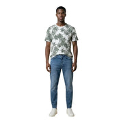 A man wearing an Antony Morato men’s white t-shirt with green palm tree print and blue jeans
