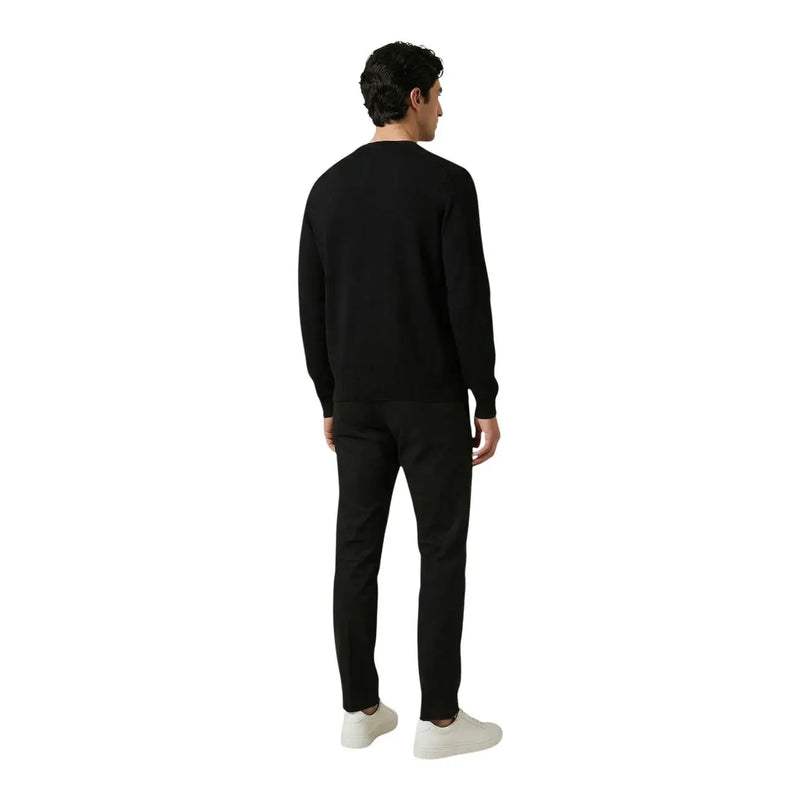 Antony Morato men trousers paired with a black crewneck sweater featuring long sleeves and a smooth fitted silhouette