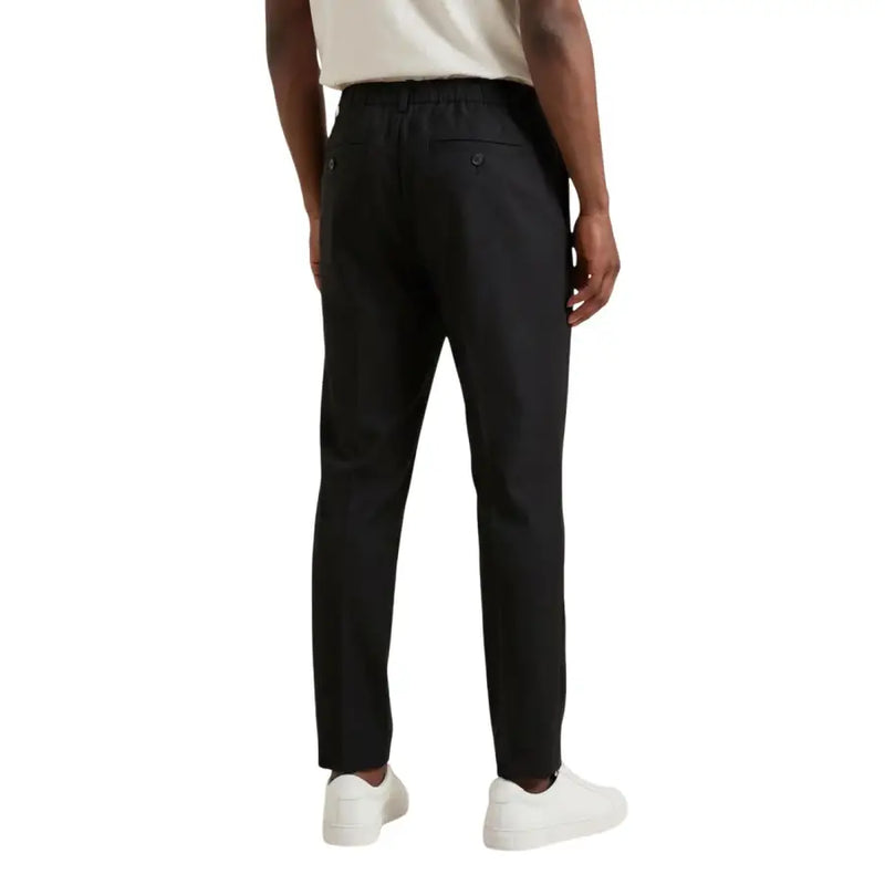 Antony morato men trousers black tailored with drawstring waistband and buttoned back pockets back side view