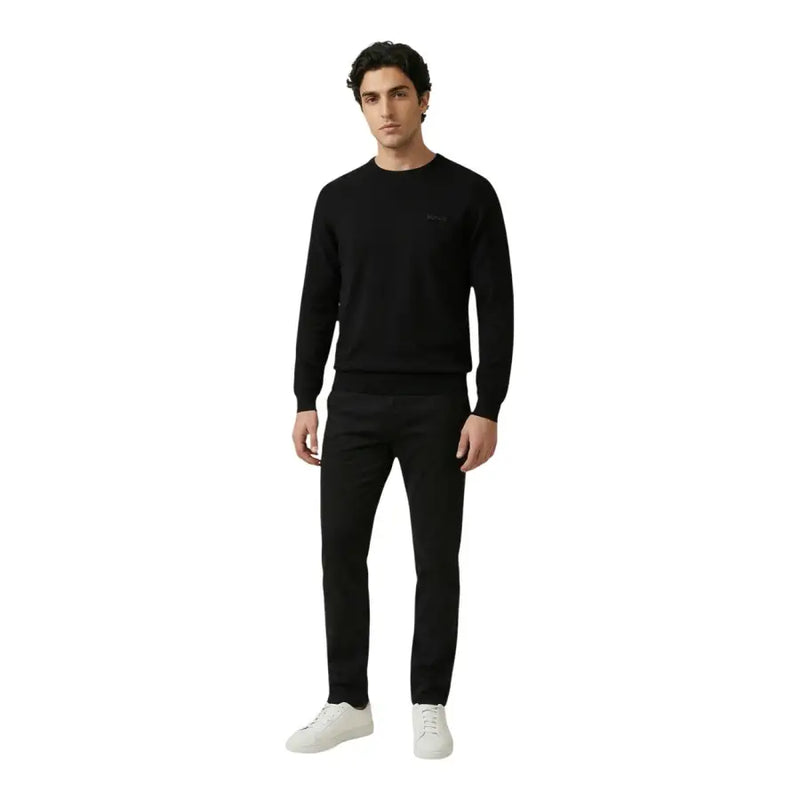 Antony Morato men trousers paired with a black knit sweater featuring a subtle embroidered logo on the left chest