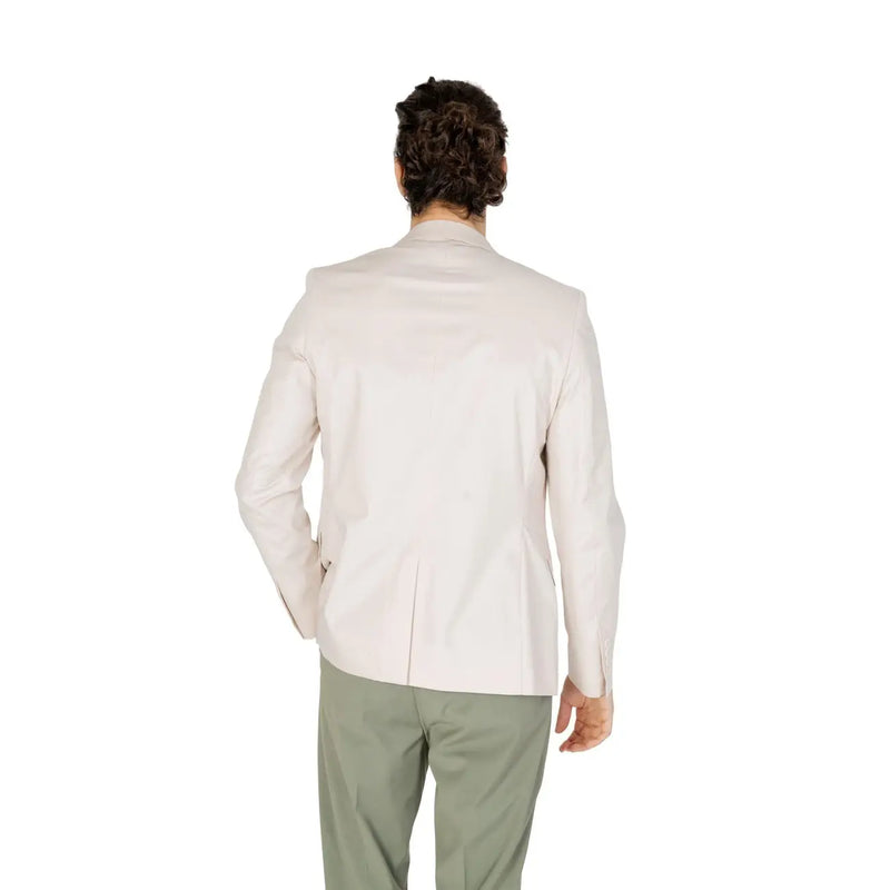A man wearing an antony morato men white cotton modal blazer with a cream-colored tailored classic fit and subtle stitching details