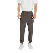 Men’s dark grey jogger pants with drawstring waist and white sneakers for casual style