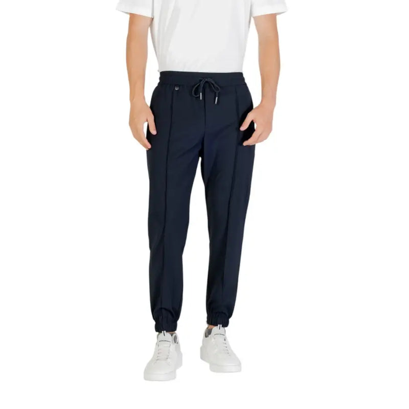 Men’s navy blue joggers with drawstring waist and white sneakers displayed with Antony Morato trousers