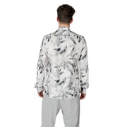 Men’s white floral long-sleeve shirt with leaf pattern paired with light grey pants
