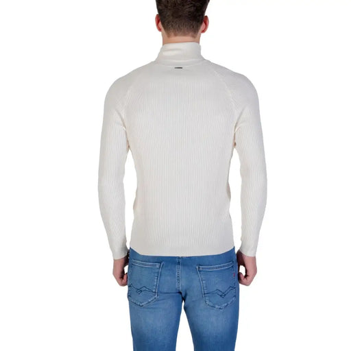 Cream ribbed turtleneck sweater with a high neck and long sleeves.