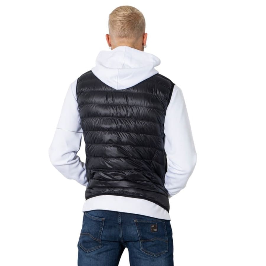 Stylish man in EA7 men jacket, black vest and white hoodie