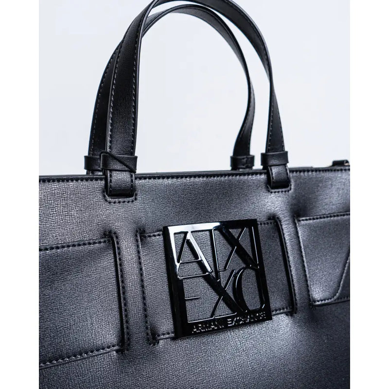 Armani Exchange black faux leather tote bag with shoulder strap and glossy black logo plaque on front