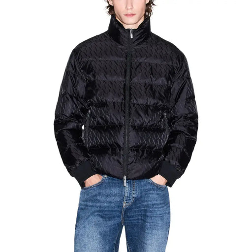 Black quilted puffer jacket with high collar and zipper closure.