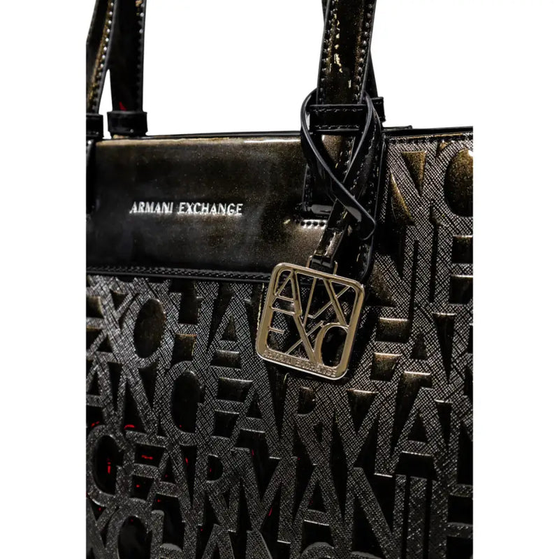 Armani Exchange black tote bag with glossy patent leather top panel and embossed logo pattern with zip pockets