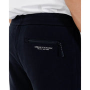 Back side view of black Armani Exchange jogger pants with zippered back pocket and white logo lettering for fall winter